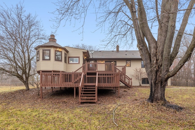 rear view of property featuring a wooden deck