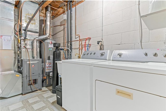 laundry room featuring washer and dryer, heating unit, and gas water heater