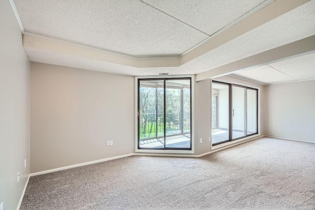 unfurnished room with a textured ceiling, carpet floors, and crown molding