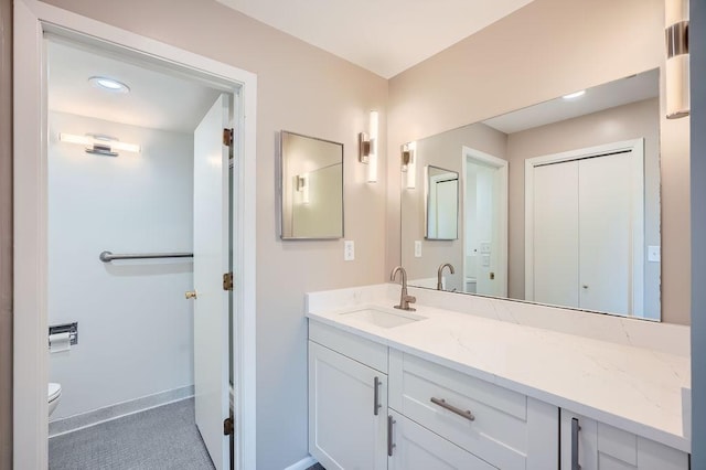 bathroom featuring toilet and vanity