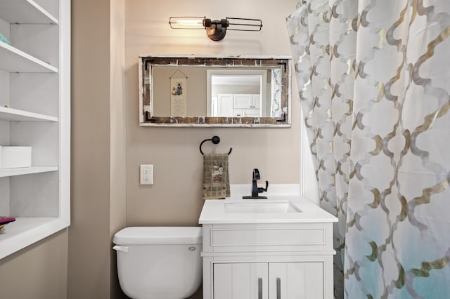 bathroom featuring toilet and vanity