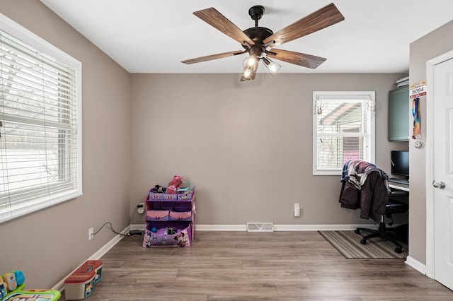 office featuring ceiling fan and light hardwood / wood-style flooring