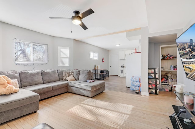 living room featuring ceiling fan and light wood-type flooring