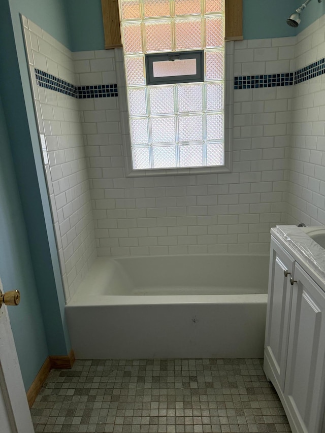 bathroom with tile patterned flooring, vanity, and tiled shower / bath combo