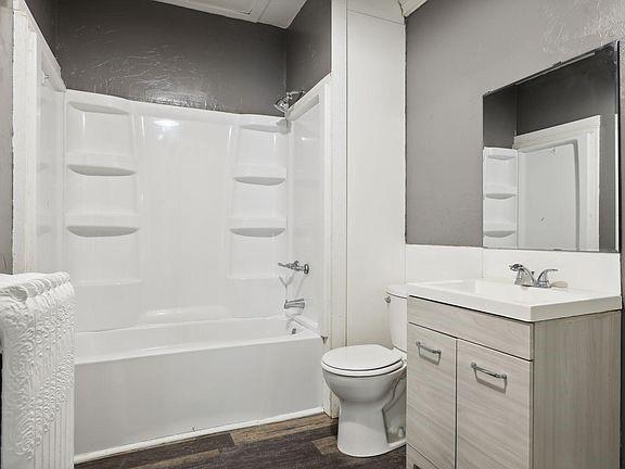 full bathroom featuring toilet, hardwood / wood-style flooring, shower / bathing tub combination, and vanity