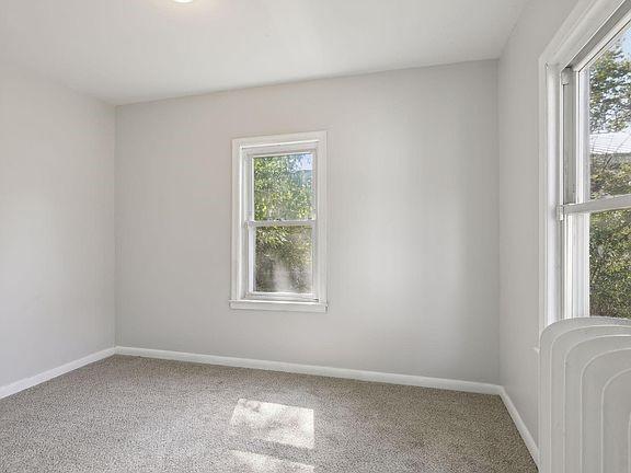 203 4th St, River Falls, WI 54022 - empty room with baseboards and carpet