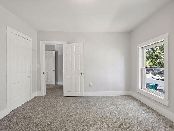 203 4th St, River Falls, WI 54022 - unfurnished bedroom featuring baseboards and carpet flooring
