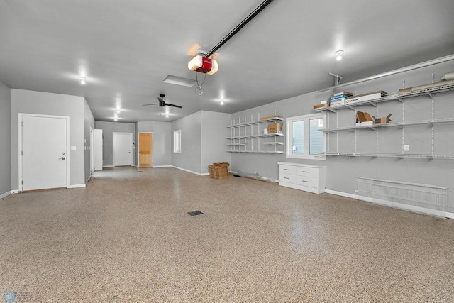 garage with a garage door opener and ceiling fan