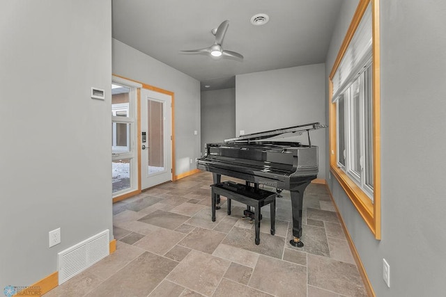 1336 Goldenwood Dr, West Fargo, ND 58078 - living area featuring stone tile floors, baseboards, and ceiling fan