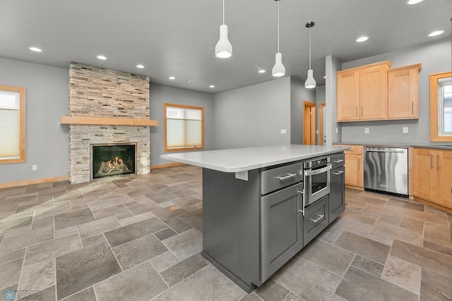 1336 Goldenwood Dr, West Fargo, ND 58078 - kitchen with stainless steel appliances, light brown cabinetry, stone tile floors, open floor plan, and recessed lighting