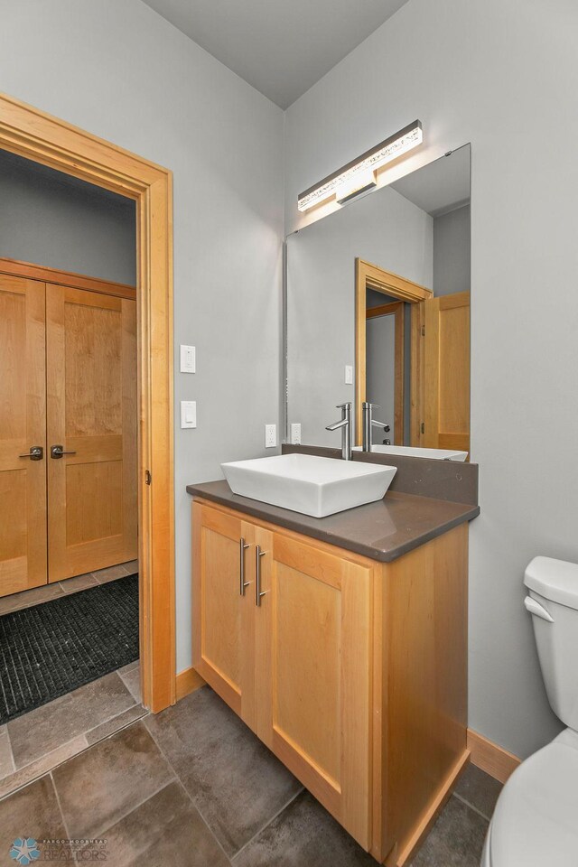 1336 Goldenwood Dr, West Fargo, ND 58078 - bathroom featuring vanity, toilet, and baseboards