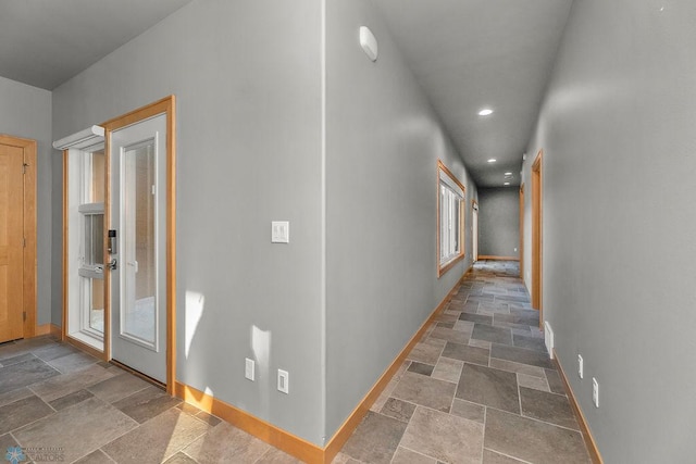 1336 Goldenwood Dr, West Fargo, ND 58078 - hallway featuring stone tile flooring, baseboards, and recessed lighting