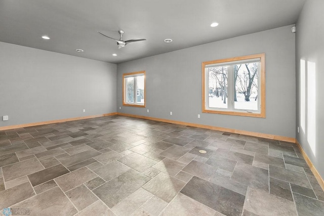 1336 Goldenwood Dr, West Fargo, ND 58078 - spare room with healthy amount of natural light, ceiling fan, baseboards, recessed lighting, and stone tile flooring