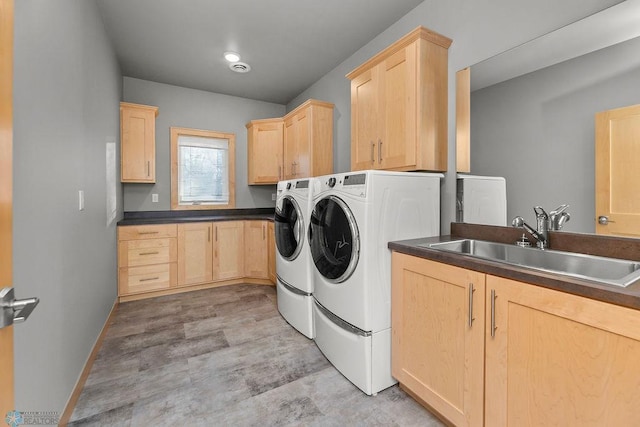 1336 Goldenwood Dr, West Fargo, ND 58078 - laundry area featuring independent washer and dryer, cabinet space, baseboards, and light floors