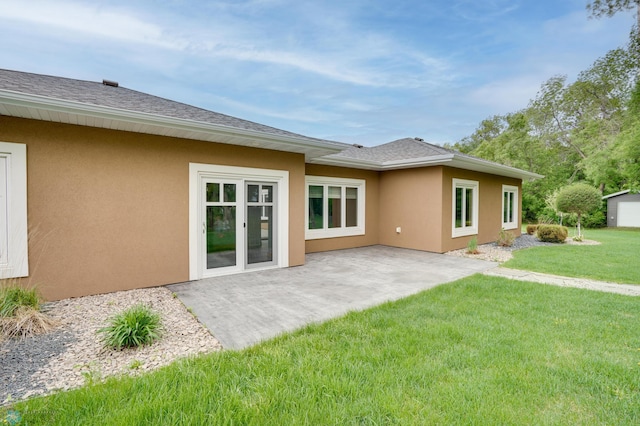 1336 Goldenwood Dr, West Fargo, ND 58078 - back of house featuring stucco siding, a lawn, a patio area, and roof with shingles