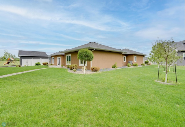1336 Goldenwood Dr, West Fargo, ND 58078 - view of home's exterior featuring a lawn and stucco siding