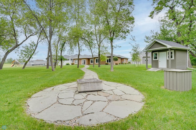 1336 Goldenwood Dr, West Fargo, ND 58078 - view of green lawn with an outbuilding and an outdoor fire pit