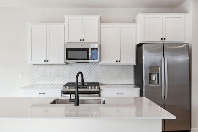 kitchen featuring sink, stainless steel appliances, and white cabinets