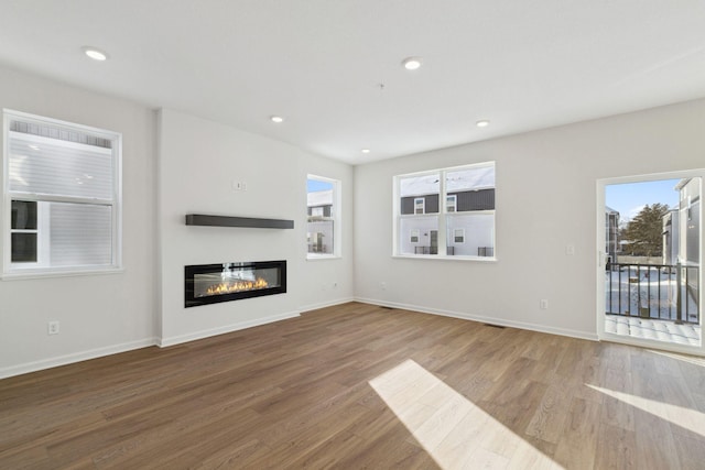 unfurnished living room with hardwood / wood-style flooring