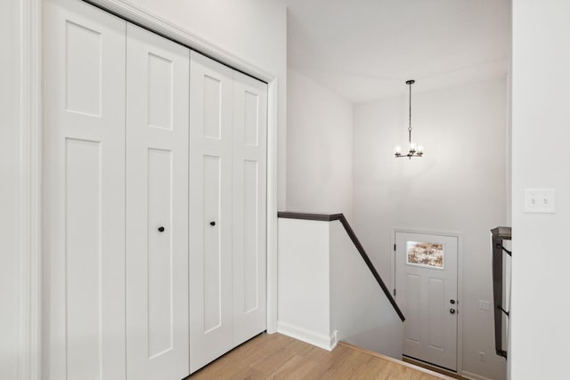 entrance foyer with a chandelier and light hardwood / wood-style floors