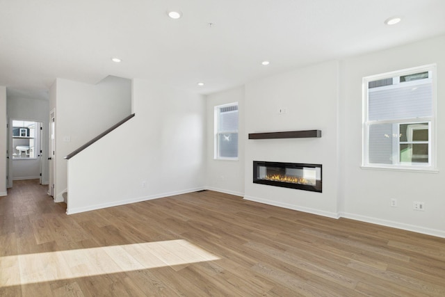 unfurnished living room with light hardwood / wood-style flooring