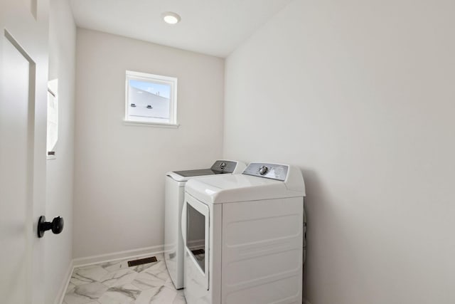 clothes washing area with washer and clothes dryer