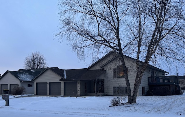 view of front of home with a garage and a wooden deck