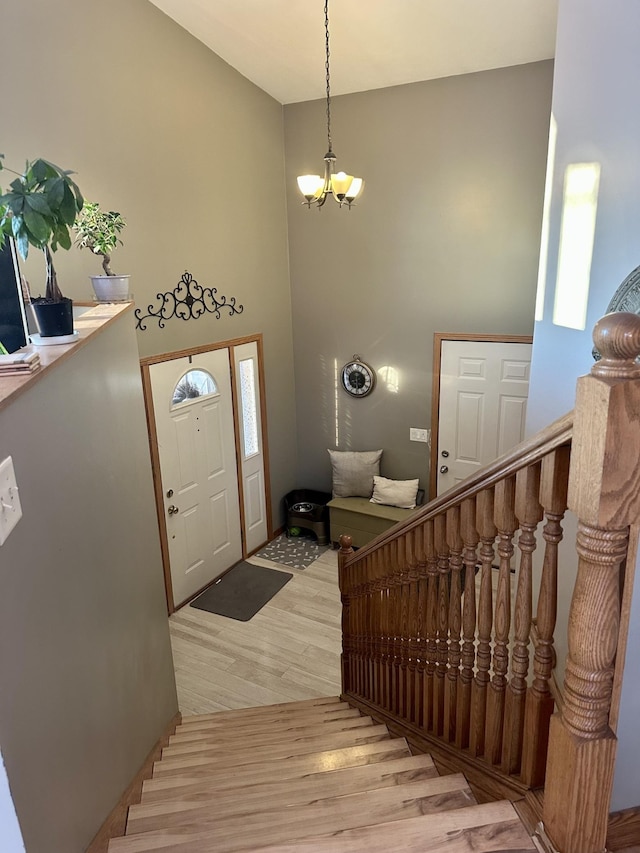 foyer entrance with light hardwood / wood-style flooring and a notable chandelier