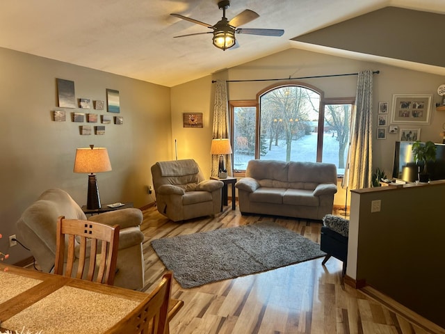 living room with lofted ceiling, ceiling fan, and hardwood / wood-style floors