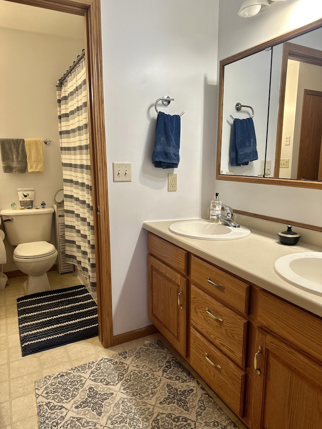 bathroom featuring toilet, vanity, tile patterned flooring, and a shower with curtain