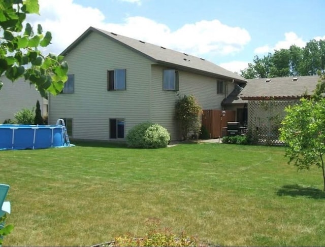 rear view of house with a yard