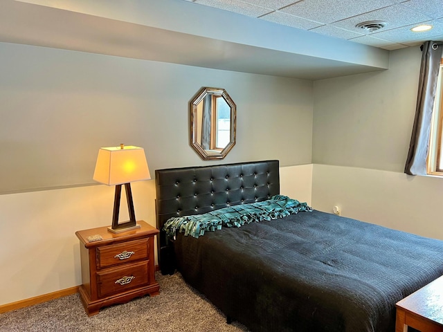 carpeted bedroom featuring a paneled ceiling