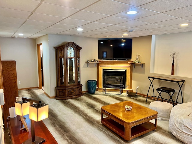 living room with wood-type flooring and a drop ceiling