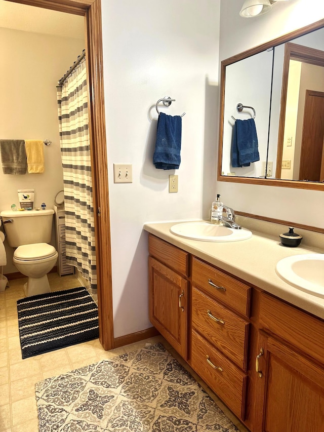 bathroom featuring vanity, tile patterned floors, toilet, and walk in shower