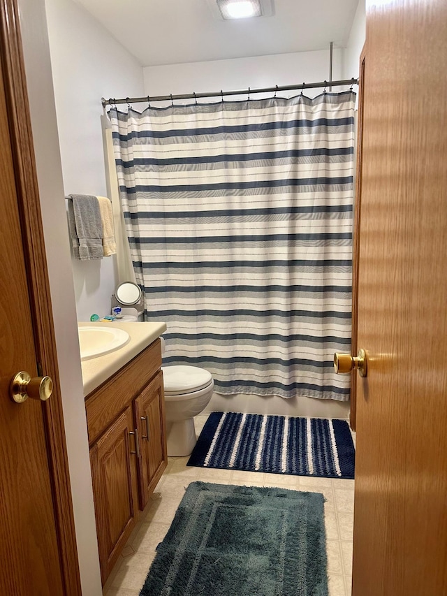 bathroom featuring vanity, tile patterned floors, and toilet