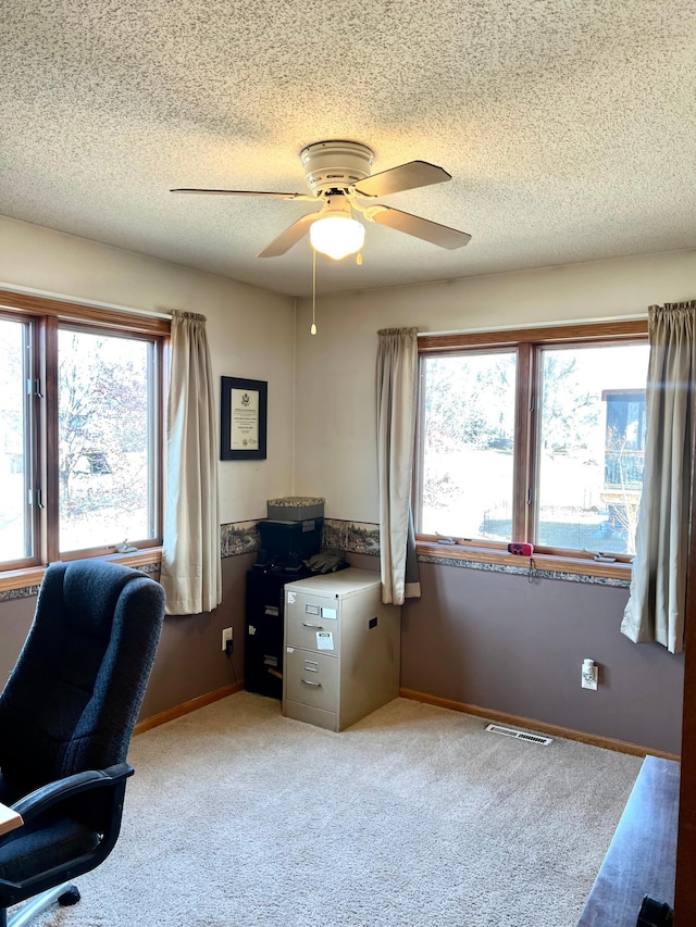 office with a textured ceiling, ceiling fan, light carpet, and baseboards