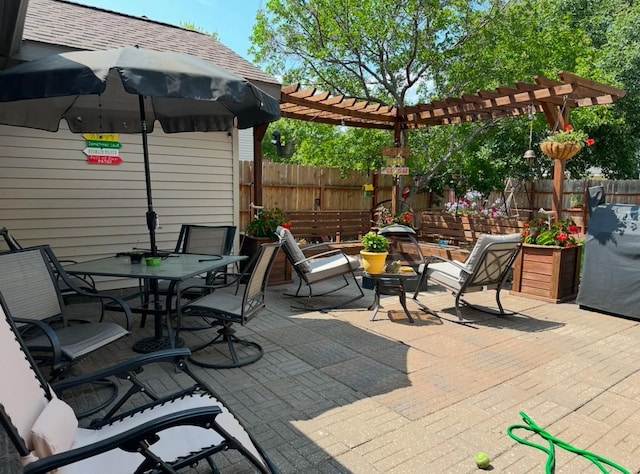 view of patio with fence, a pergola, and outdoor dining space