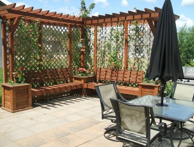 view of patio with outdoor dining area and a pergola