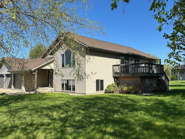 back of property with a yard and a wooden deck