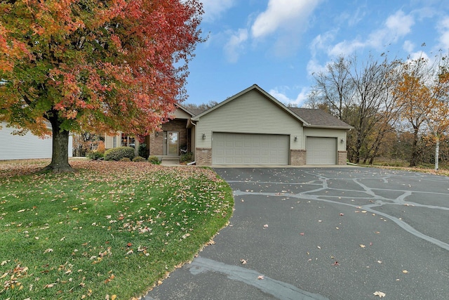 view of front of home featuring a front yard and a garage