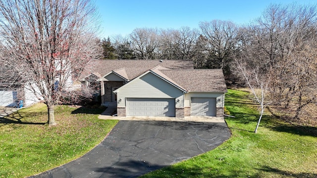 ranch-style house featuring a front yard and a garage