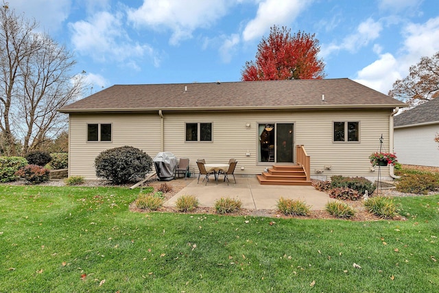 rear view of house featuring a patio and a yard