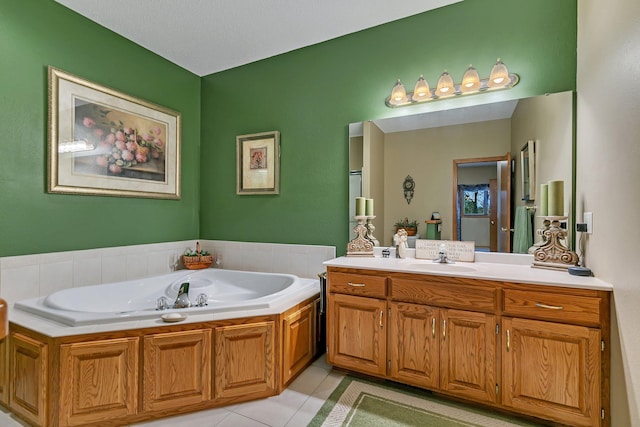 bathroom with a bath, vanity, and tile patterned floors