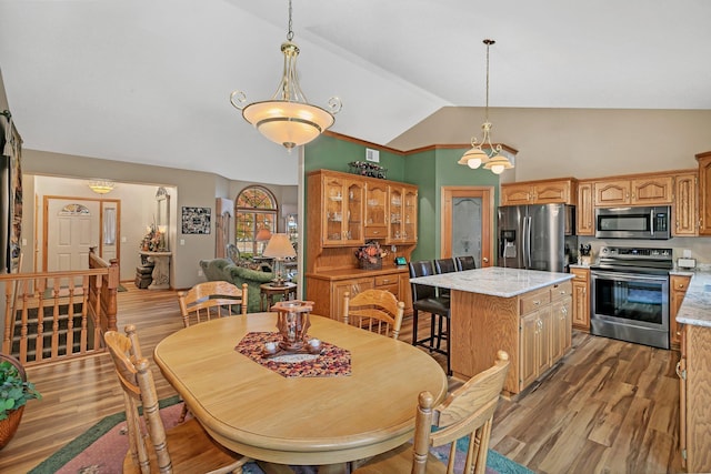 dining area featuring lofted ceiling and hardwood / wood-style floors