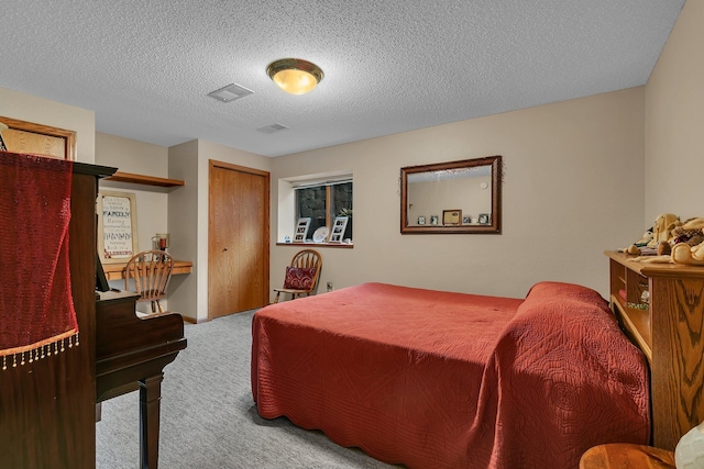 bedroom with a textured ceiling and carpet