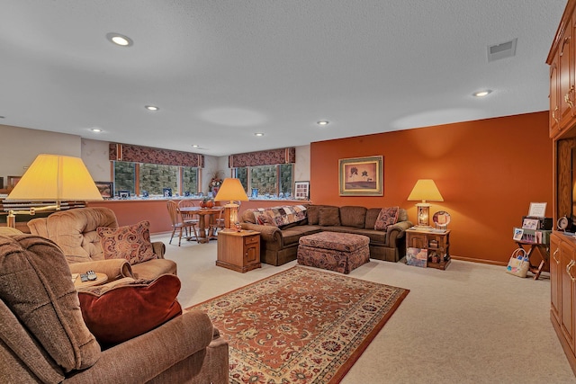 living room with a textured ceiling and light carpet