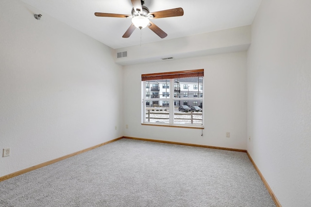 unfurnished room featuring ceiling fan and carpet floors