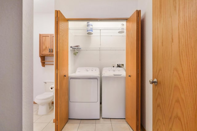 laundry area featuring light tile patterned floors and independent washer and dryer