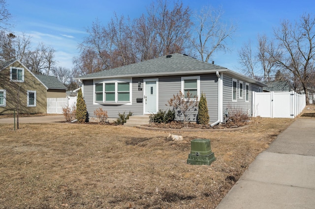 bungalow-style house featuring fence, a shingled roof, and a gate