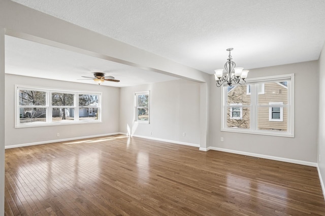 unfurnished room featuring baseboards, a textured ceiling, hardwood / wood-style floors, and ceiling fan with notable chandelier